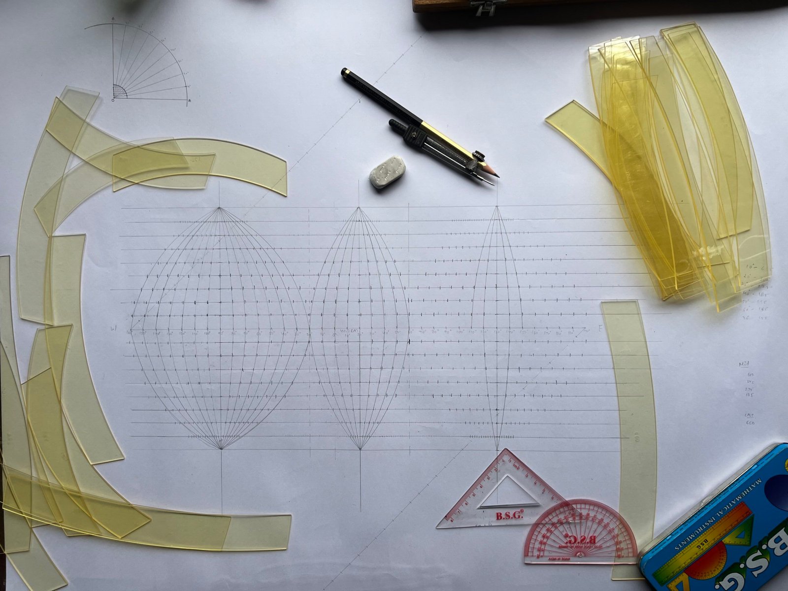 Drawing tools and curved templates arranged around the early framework of an interrupted Sanson-Flamsteed projection