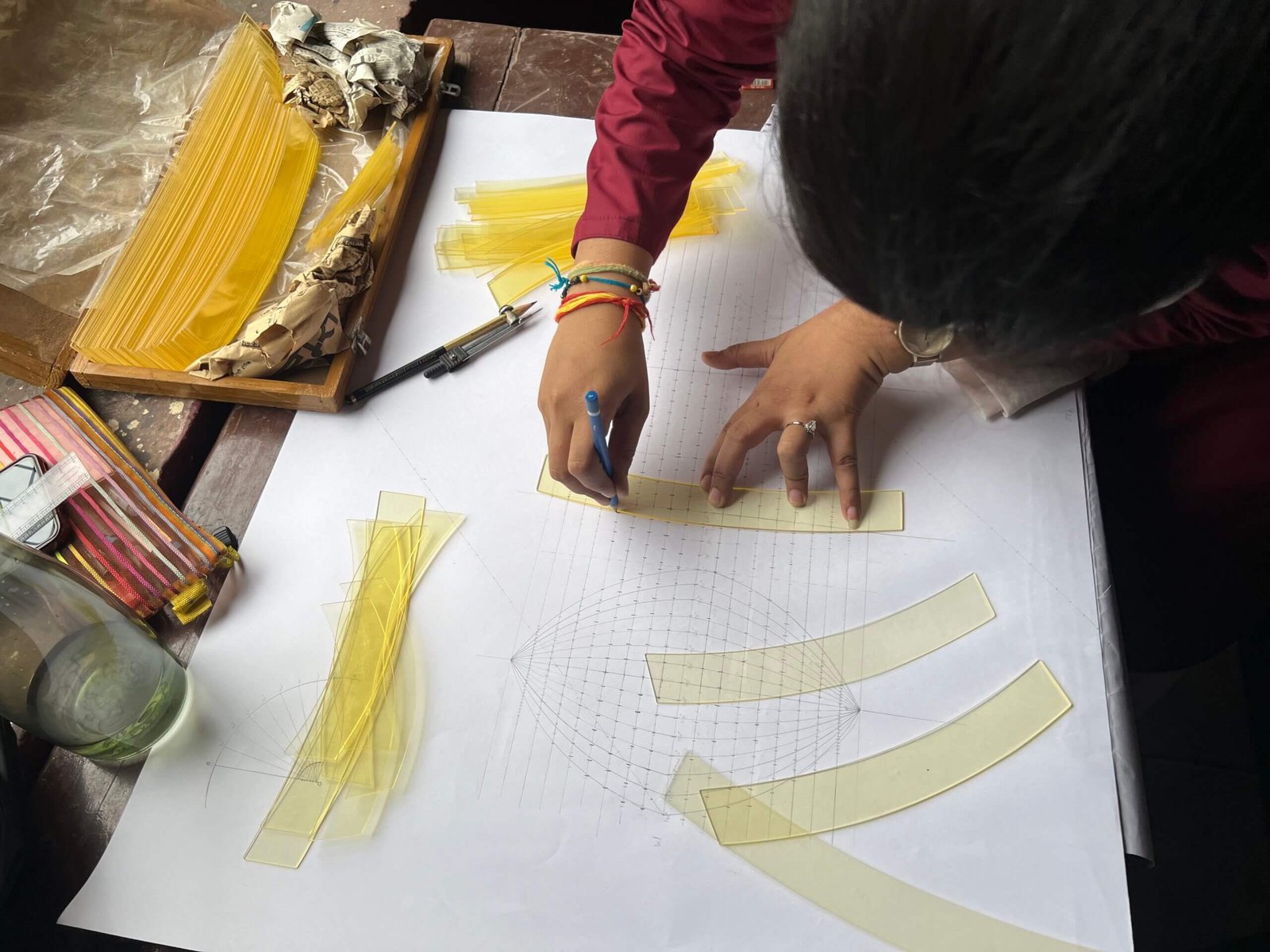Curved templates being aligned with plotted coordinate points on the projection